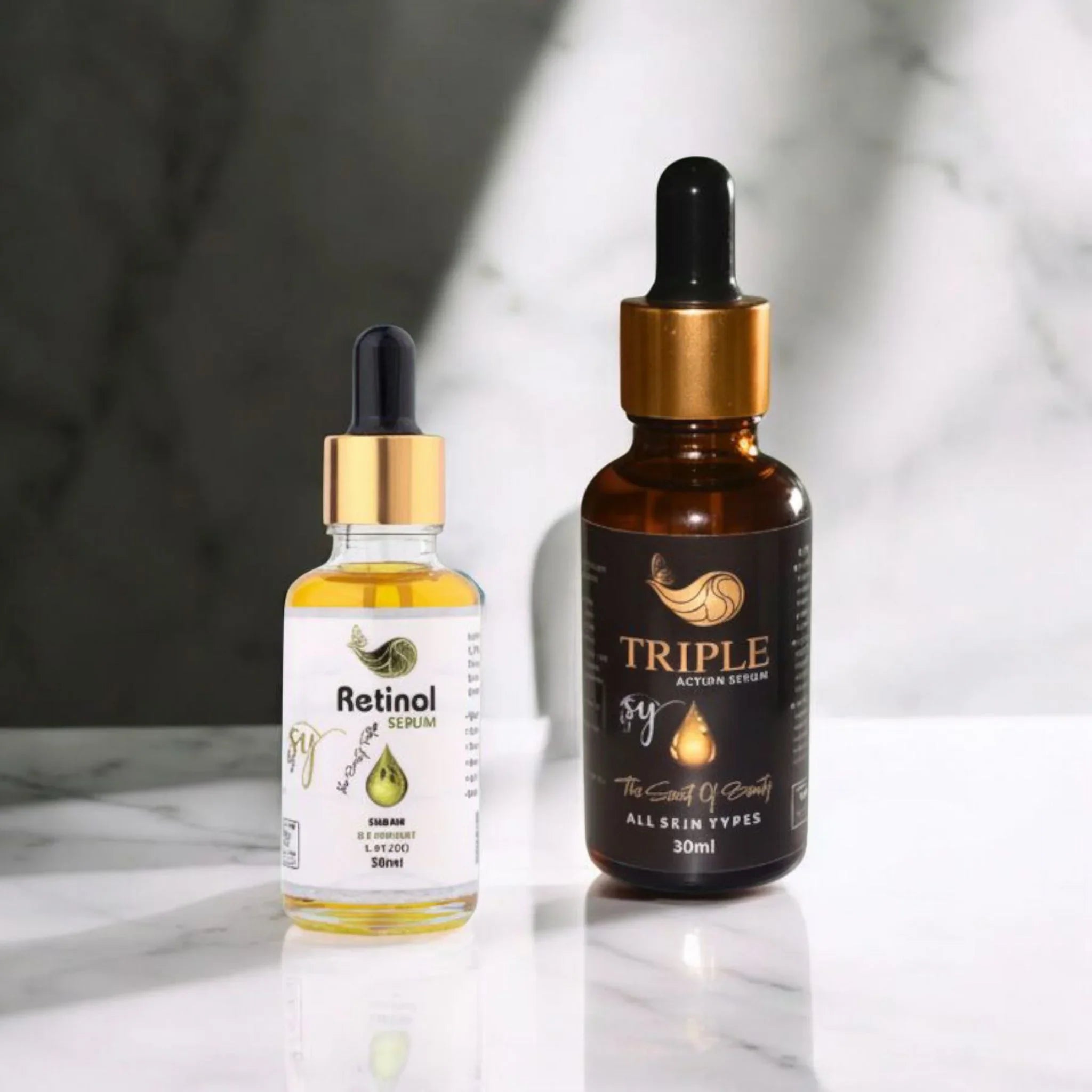 Retinol serum and triple action serum skincare bottles with droppers on marble surface